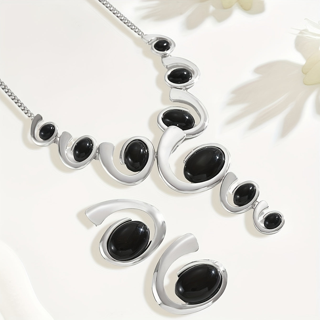 Two-piece Women's jewelry set: one spiral snail-shaped black rhinestone gradient Y-necklace and a pair of spiral snail-shaped black rhinestone earrings, classic versatile design for daily wear or party occasions