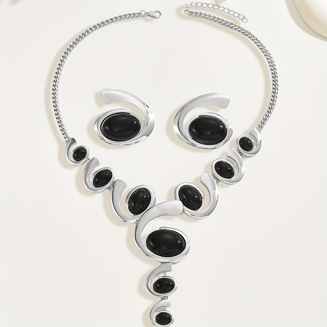 Two-piece Women's jewelry set: one spiral snail-shaped black rhinestone gradient Y-necklace and a pair of spiral snail-shaped black rhinestone earrings, classic versatile design for daily wear or party occasions